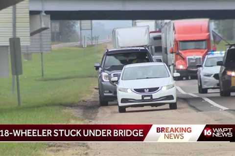 Truck gets stuck under an overpass